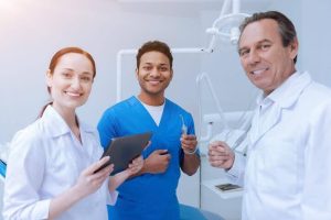 A pair of CADH students with an instructor while preparing for the dental hygiene board exam