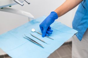 A dental assistant preparing instruments for a procedure after completing a dental assistant course