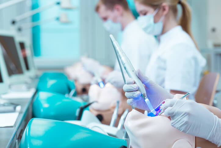 A student learning to use ultrasonic dental tools in the lab