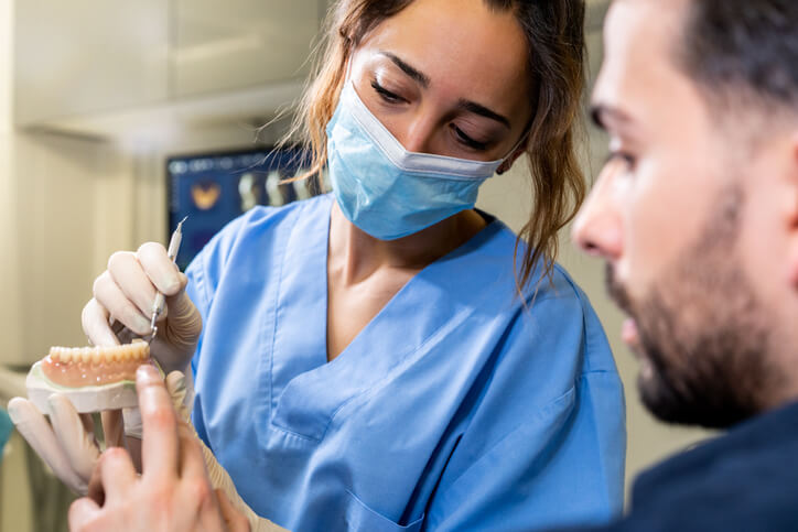 A dental hygiene student learning proper patient care techniques