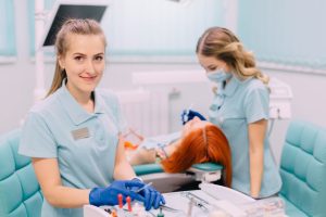 A pair of students demonstrating the dental assistant skills required in modern dental clinics