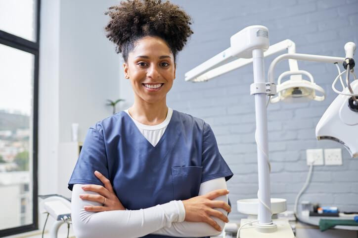 A dental hygienist practicing patient care after completing dental hygienist training