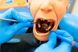 A dental hygiene student in clinical training is learning how long it takes to become a dental hygienist