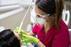 A dental hygienist performing a preventive cleaning during a patient appointment