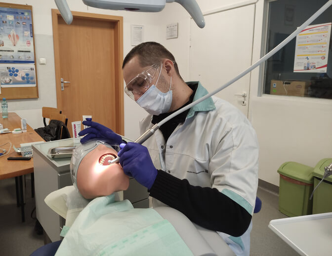 A dental hygiene student practicing clinical skills during training