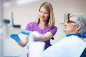 A level I dental assistant providing chairside assistance in an Ontario dental office